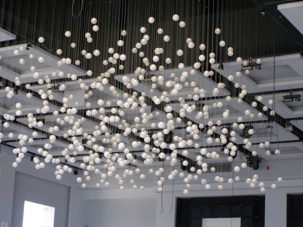 A photo of little lights hanging from the ceiling